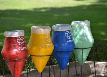 A row of soda bottles sitting on top of metal stands.