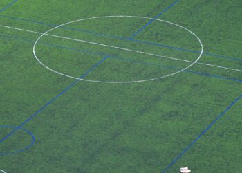 A soccer field with a goal post and the markings for the ball.