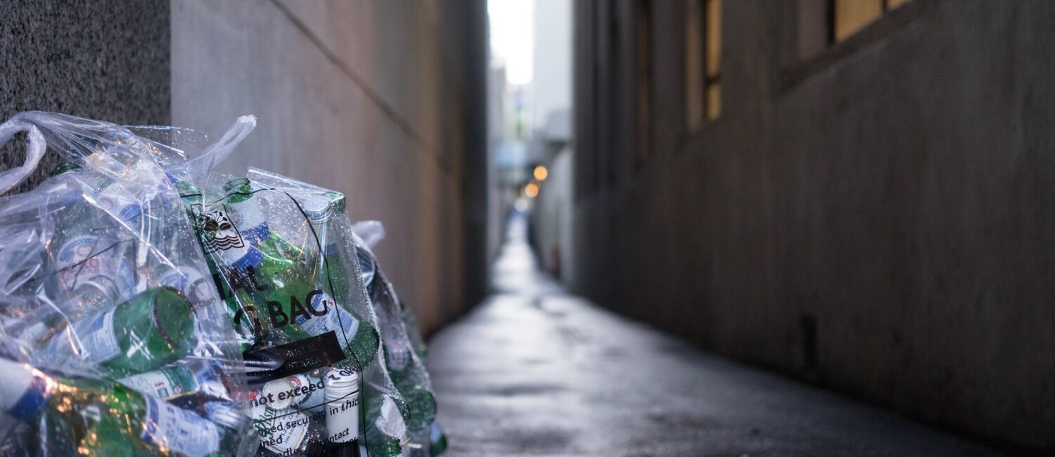 A bottle of water is sitting on the side walk