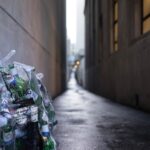 A bottle of water is sitting on the side walk