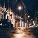 A car parked on the side of a street at night.