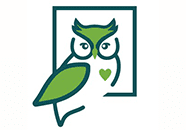 A green owl sitting in front of a picture.