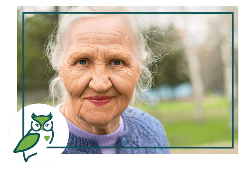 An old woman with a owl on her head.