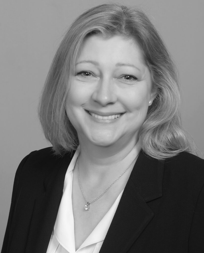 A black and white photo of a woman in a suit.