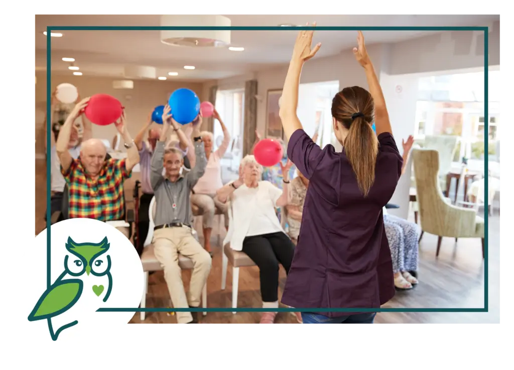 A group of people sitting in chairs holding balloons.